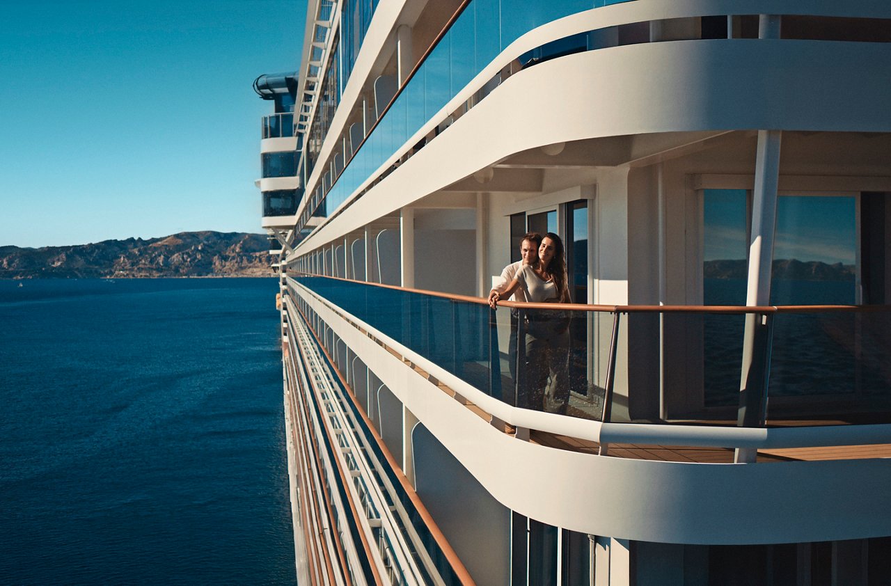 A couple enjoys the sea view from the balcony of a cruise ship | MSC Cruises