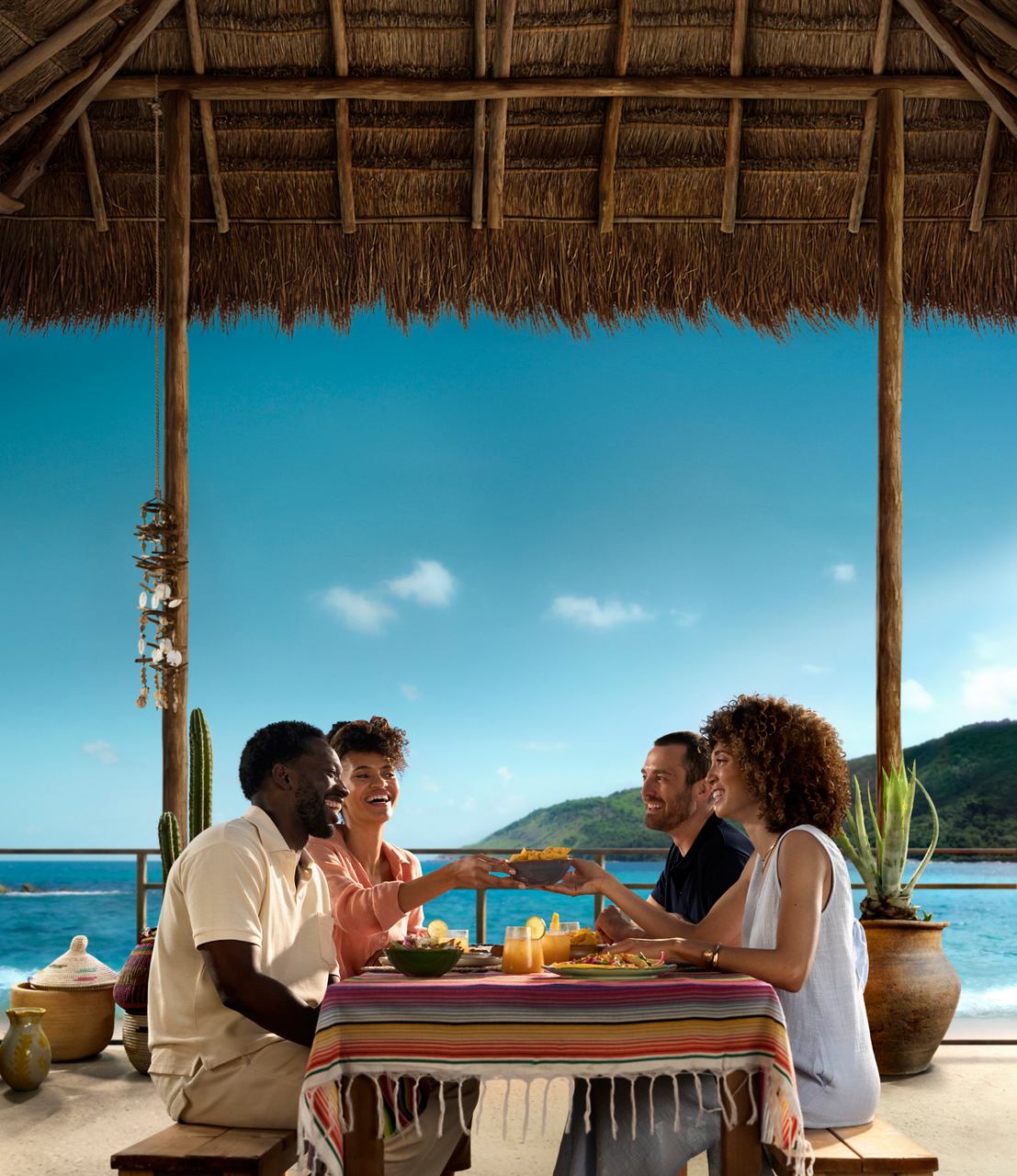 A group of friends enjoys a meal on the beach with a view of the sea | MSC Cruises