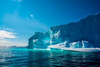 An iceberg in Ilulissat, Greenland, reflects the beautiful blue tones of the sea | MSC Cruises