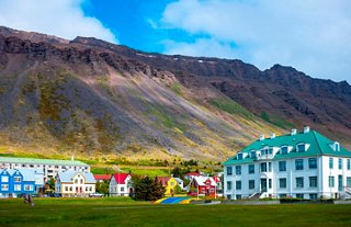 Scenic landscape of Iceland featuring houses and majestic mountains | MSC Cruises