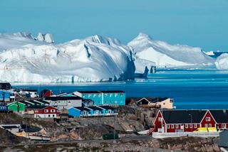 Village in Greenland with glaciers in the background and bright blue sea | MSC Cruises