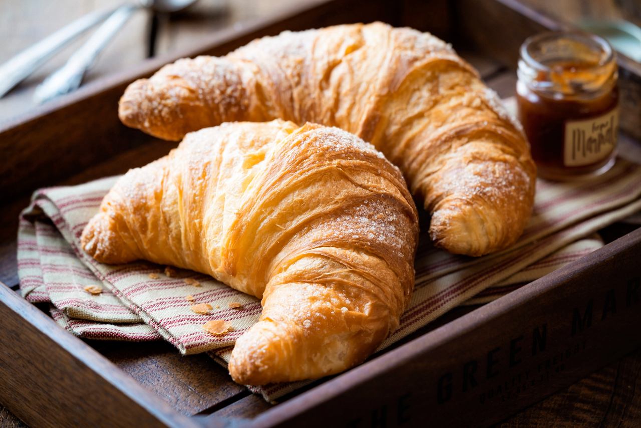 Fresh croissants served in a cozy basket with honey | MSC Cruises