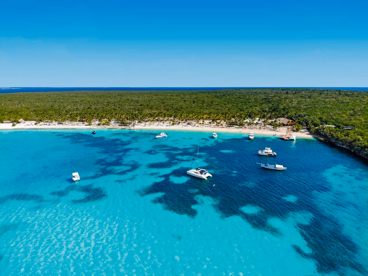 Aerial view of crystal-clear sea and beach surrounded by greenery in the Dominican Republic | MSC Cruises