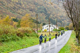 Staff with bikes on street with houses and trees in Norway | MSC Cruises
