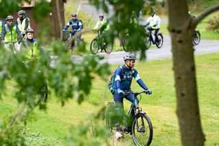 Staff leading a bike tour through lush vegetation in Norway | MSC Cruises