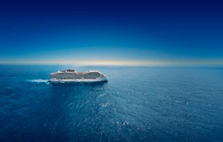 Aerial view of MSC World Europa cruise ship sailing on the sea under clear sky | MSC Cruises