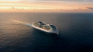 MSC World Asia sails across calm seas at sunset, surrounded by a vast open sky | MSC Croisières