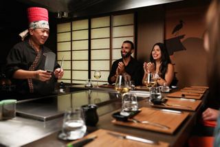 Chef prepares food for a couple at the specialty restaurant aboard the cruise ship | MSC Cruises