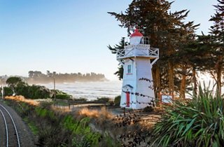 Lighthouse by the sea with lush greenery in Timaru, New Zealand | MSC Cruises