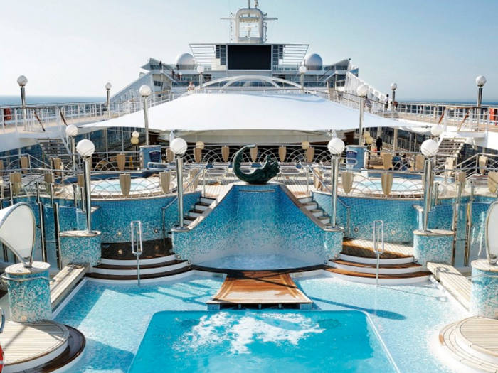 Outdoor pool on a cruise ship with spacious deck and relaxing lounge area | MSC Cruises