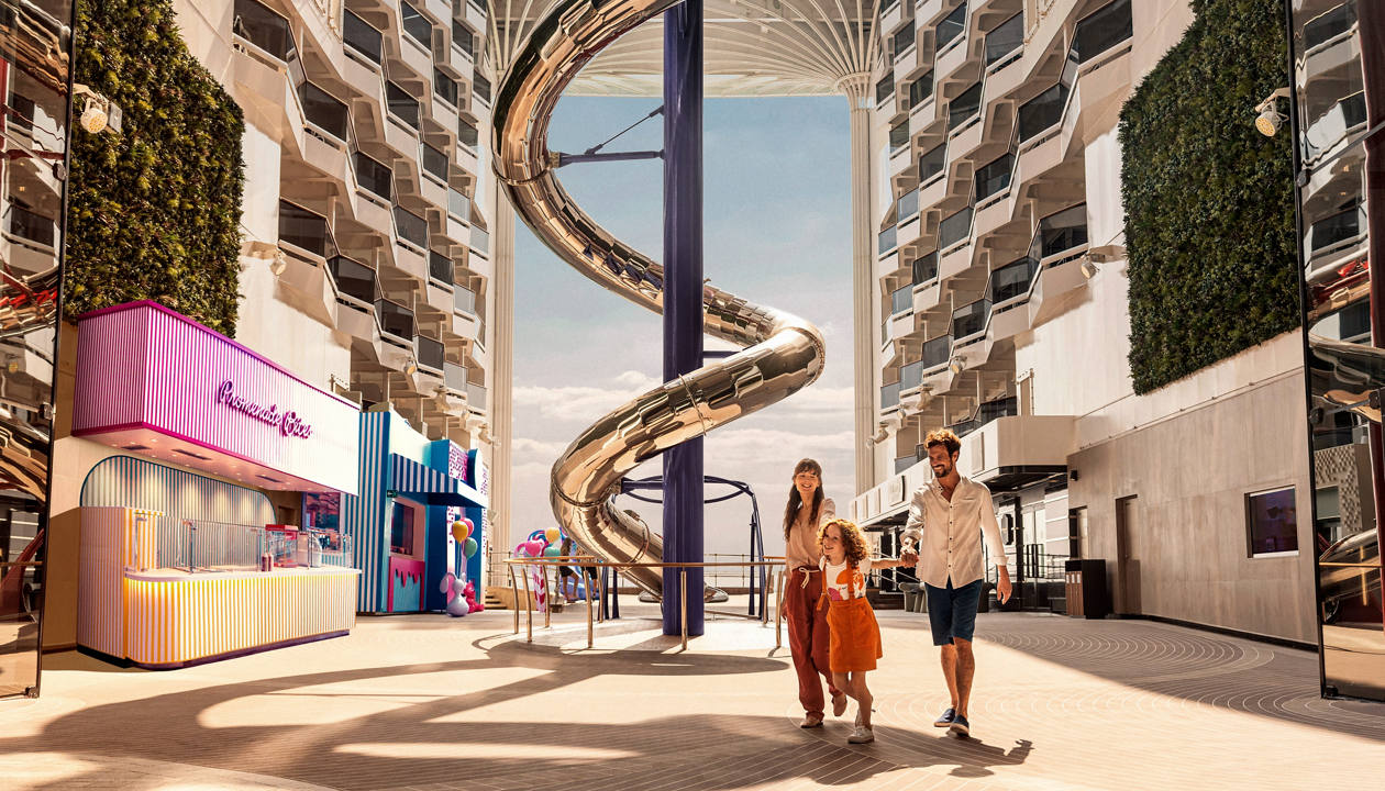 Spacious cruise promenade featuring modern shops and a spiral slide for entertainment | MSC Cruises