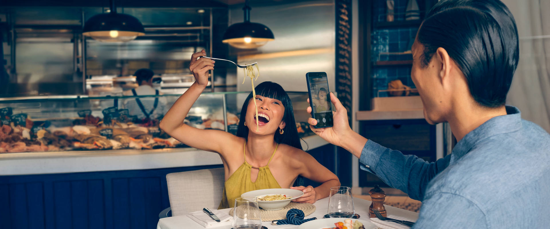 A couple enjoys dinner together in a comfortable restaurant setting | MSC Cruises