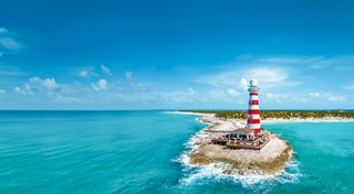 Aerial view of an island with a ship surrounded by the turquoise waters of the Caribbean | MSC Cruises