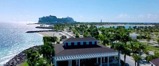 An aerial shot of Ocean Cay MSC Marine Reserve with an MSC Cruises Seaside class ship in the background.