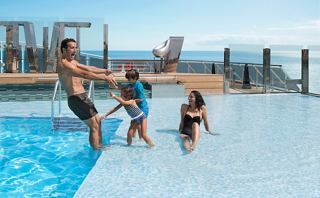 Family enjoys fun moments in the pool with a stunning ocean view | MSC Cruises
