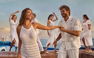 Les invités dansent joyeusement ensemble sur le pont, célébrant une atmosphère de fête vibrante au coucher du soleil | MSC Cruises