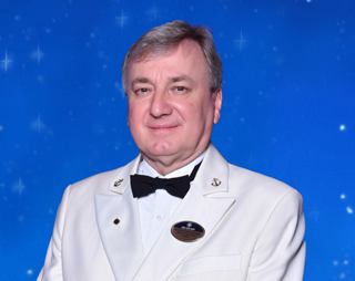 Crew officer standing with hands behind back | MSC Cruises