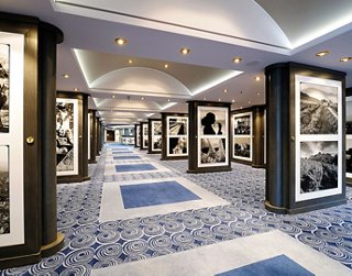 Spacious corridor with lighting and displayed art pieces | MSC Cruises