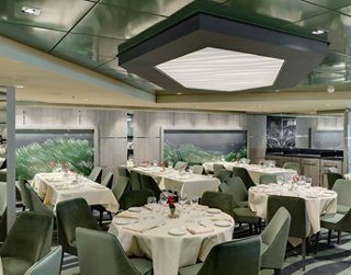Modern restaurant featuring elegant tables and greenery | MSC Cruises
