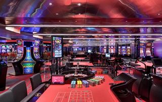 A modern casino featuring vibrant gaming tables and slot machines | MSC Cruises