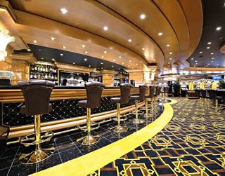 A stylish bar area with elegant seating and a warm atmosphere invites guests to relax and enjoy their time | MSC Cruises