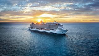A majestic cruise ship sailing on calm waters at sunset, surrounded by a beautiful sky | MSC Cruises