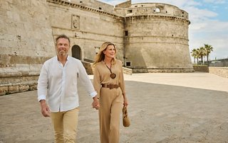A couple joyfully strolls together in a picturesque outdoor setting | MSC Cruises