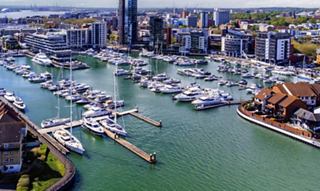 City marina with yachts and modern waterfront buildings | MSC Cruises