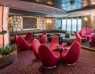 A warm and inviting lounge area with stylish pink seating and a welcoming atmosphere for relaxation | MSC Cruises