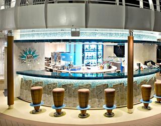 A stylish bar area with high stools and a modern counter, inviting guests to enjoy delicious drinks | MSC Cruises