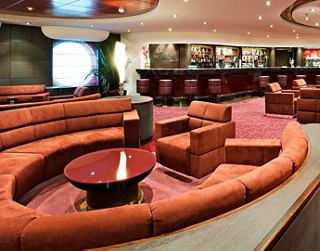 A stylish bar area with comfortable seating and a welcoming atmosphere awaits guests on board | MSC Cruises