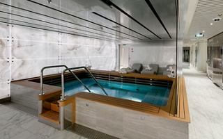 A serene spa area featuring a relaxation pool surrounded by elegant furnishings and calming decor | MSC Cruises