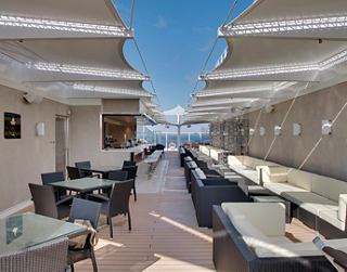 Modern restaurant setting with a sea view and comfortable seating | MSC Cruises
