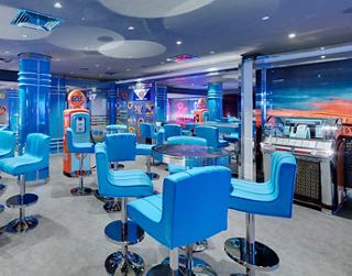 A vibrant bar space with comfortable blue seating, perfect for relaxation and enjoyment | MSC Cruises