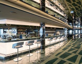 Modern bar with a minimalist design, ready to welcome guests in a cozy atmosphere | MSC Cruises