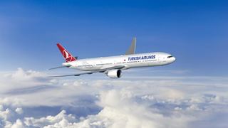 Passenger aircraft soars above clouds and a vibrant blue sky | MSC Cruises