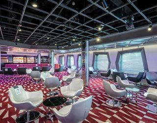 A vibrant lounge area with stylish seating and large windows, perfect for relaxation and socialising | MSC Cruises