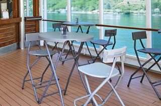 Bright and inviting bar with tables and chairs, perfect for relaxation | MSC Cruises
