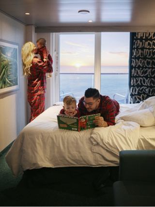 Family enjoys relaxing together in a cozy cabin with ocean view and inviting ambiance | MSC Cruises